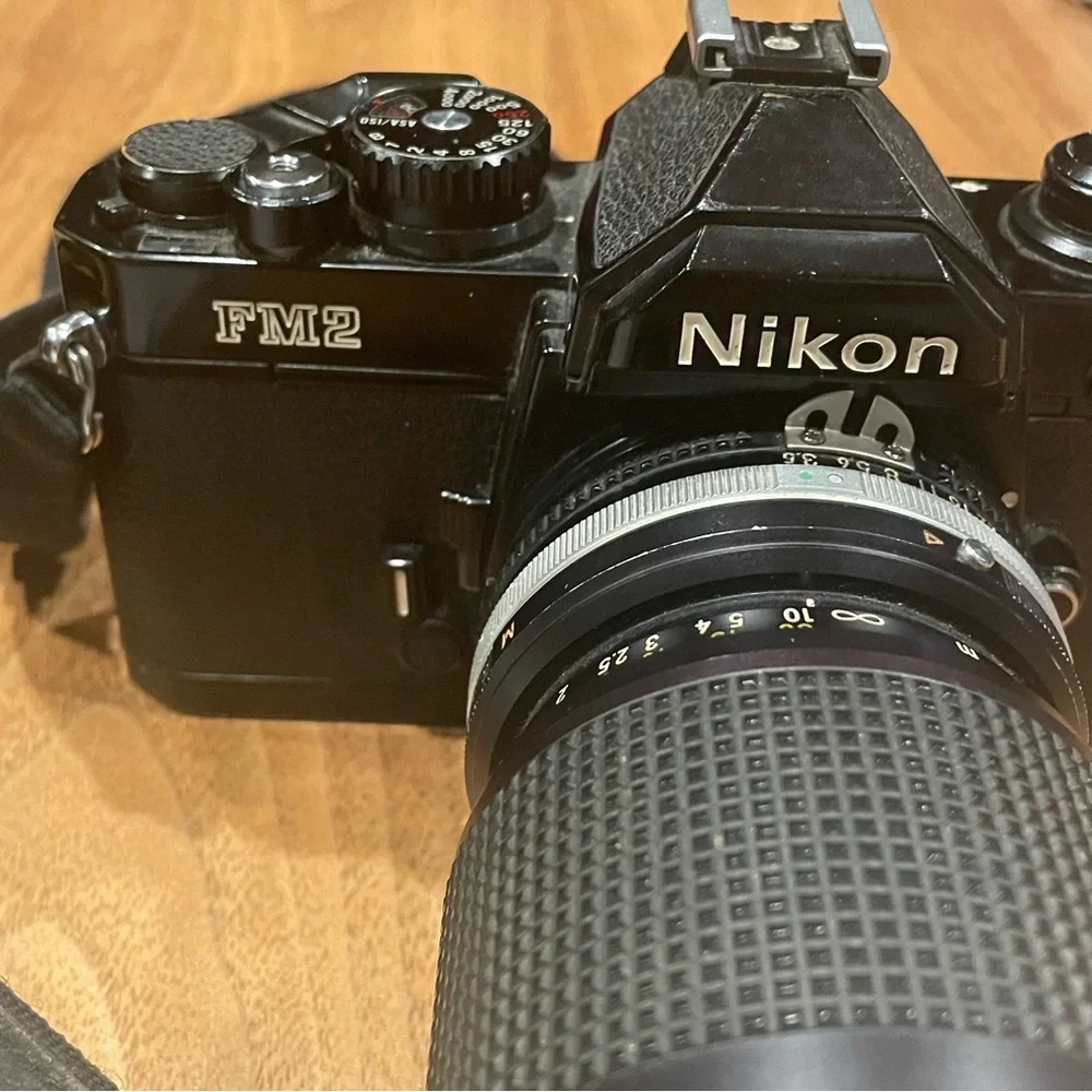 Vintage Nikon FM2 black camera with lens